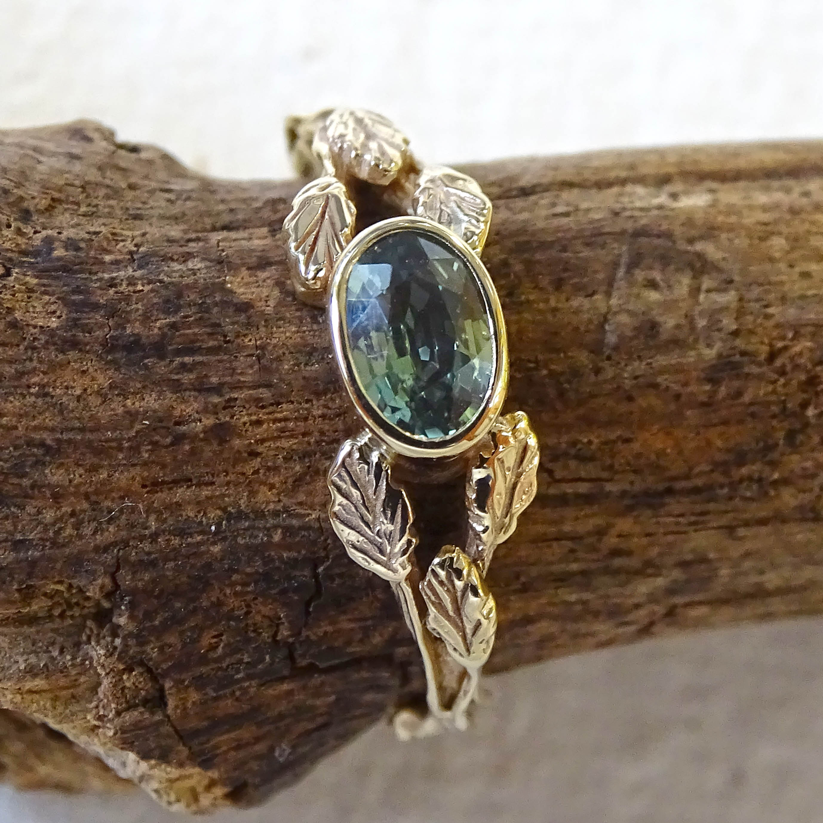 Entwining Leaves ring, 9ct yellow gold, 6mm x 4mm Green Sapphire